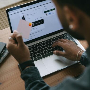 Person shopping online using a laptop and credit card.